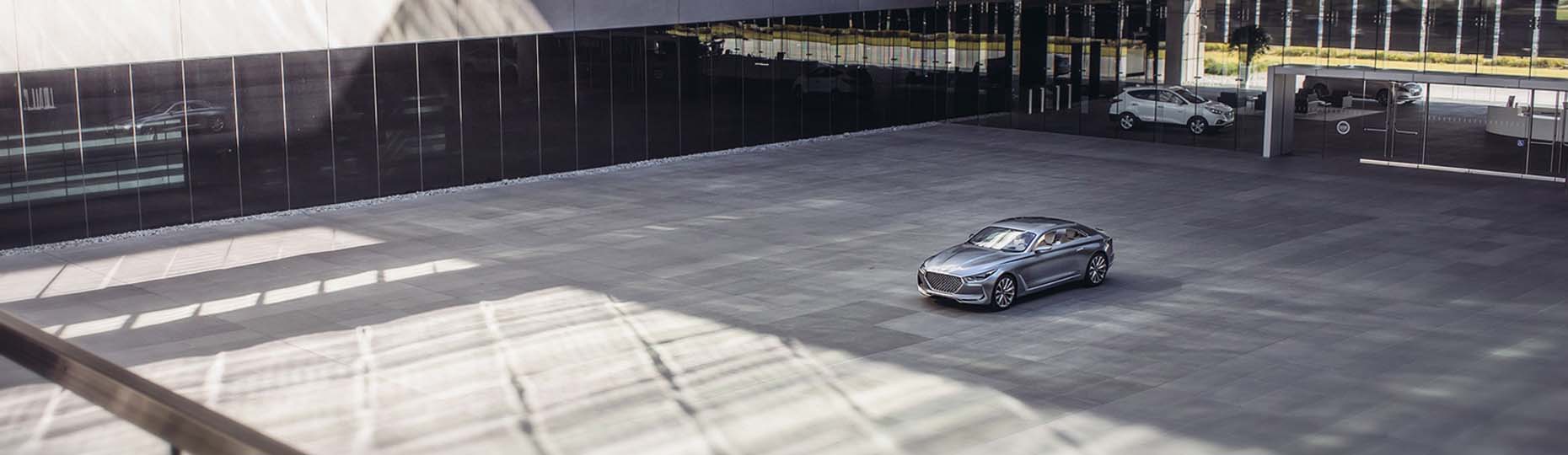 Side front view of car on the square beside building.